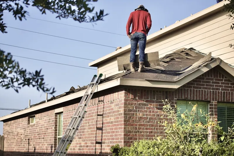 Professional roofer working on a residential roof in Heritage Crossing